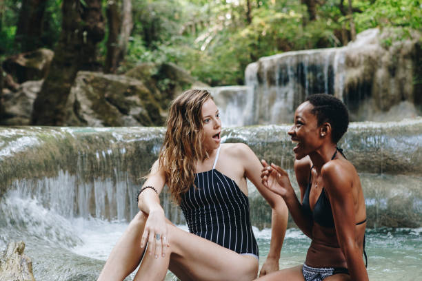 istock Women couple enjoying the waterfall 935876842