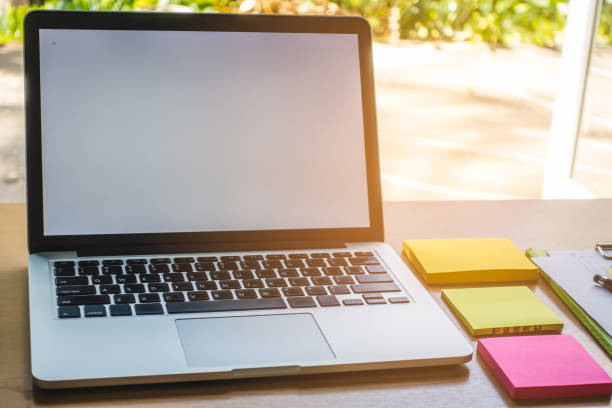 istock Business Technologies. Workplace with open laptop on modern wooden desk. 935898202