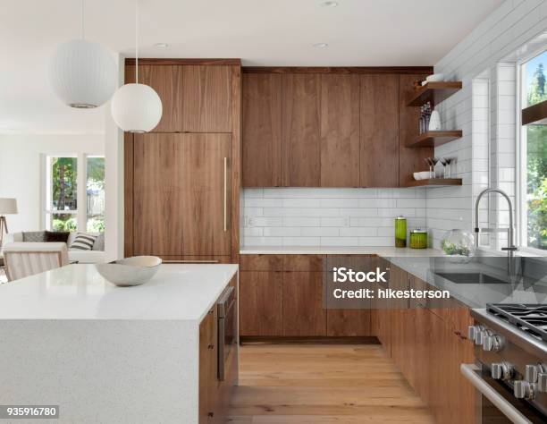 Beautiful Kitchen In New Luxury Home With Island Pendant Lights And Hardwood Floors Stock Photo - Download Image Now