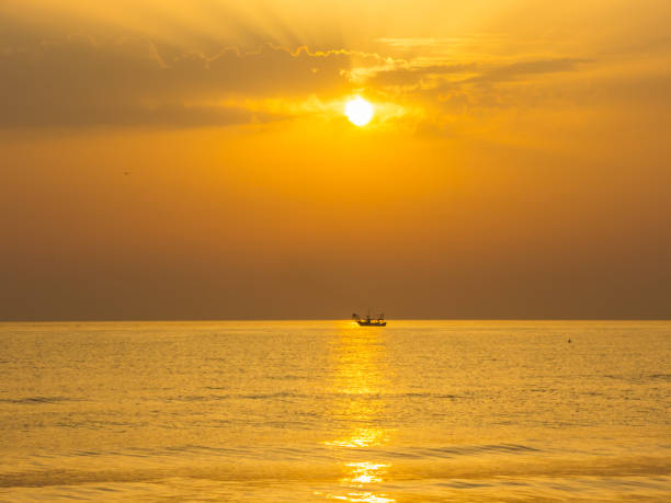 istock Fishing boats pull their nets at the sunrise. Adriatic cost. Emilia Romagna. Italy 935918948