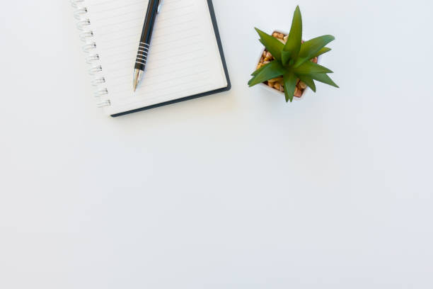istock Modern White office desk table with pen and notebook. Top view with copy space.Working desk table concept. 935925330