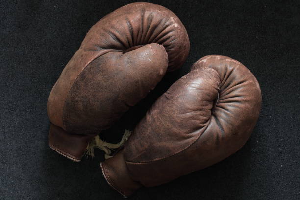 istock Lacing the old shabby boxing glove 935926992