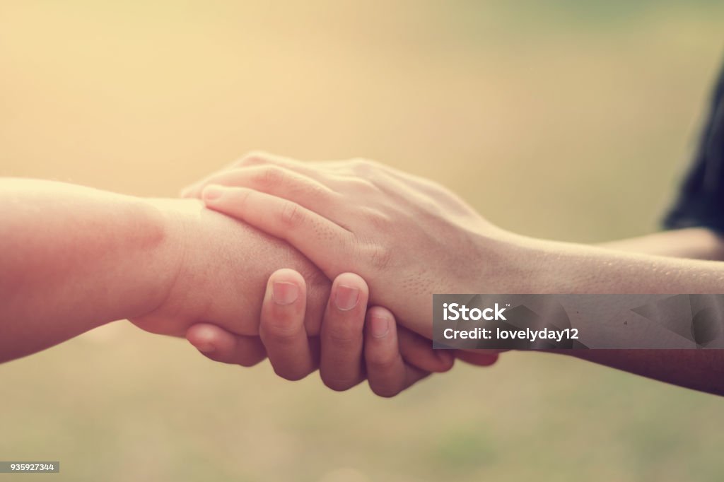 people old and young hand holding with sunset background Hand Stock Photo