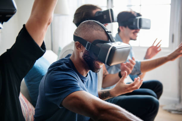 istock Group of diverse friends experiencing virtual reality with VR headset 935929854