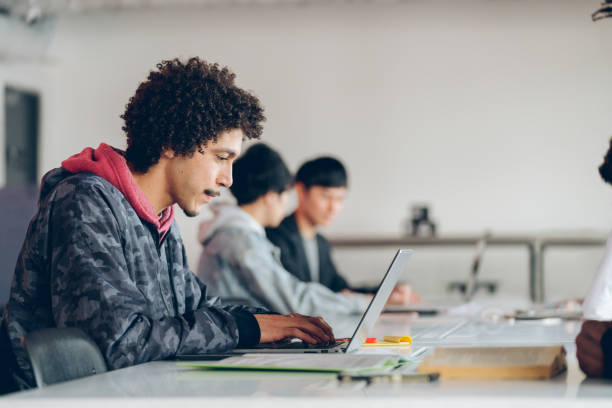 istock Young adult male working in a modern share office 935932984