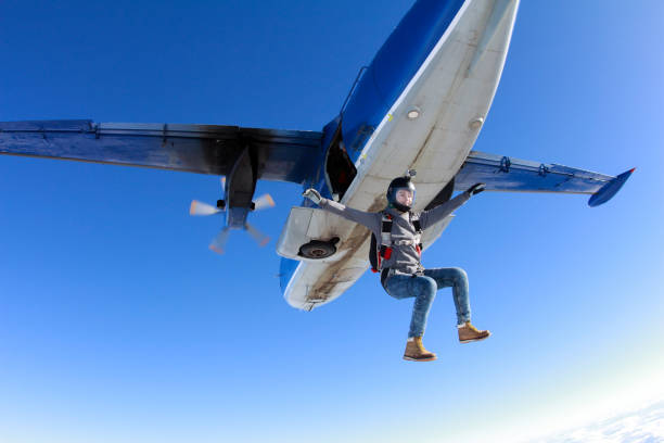istock Skydiving. Pretty girl is flying in the cold sky. 935942012