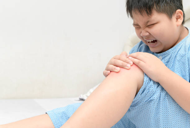 istock Obese fat boy suffering from knee pain 935947534