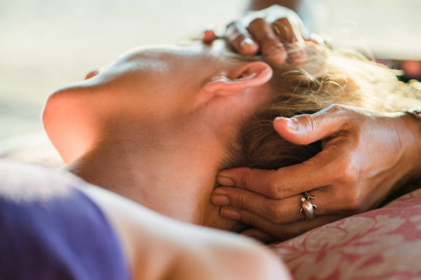 close up of a woman having head massage at the spa. - thai ethnicity massaging thailand thai culture imagens e fotografias de stock