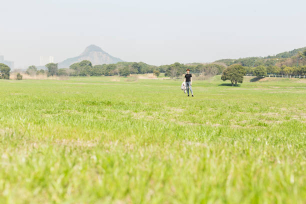 young woman relaxing on the grassy field,china.
