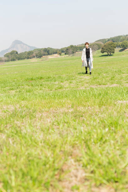 young woman relaxing on the grassy field,china.