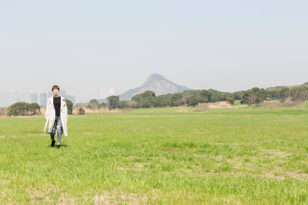 young woman relaxing on the grassy field,china.