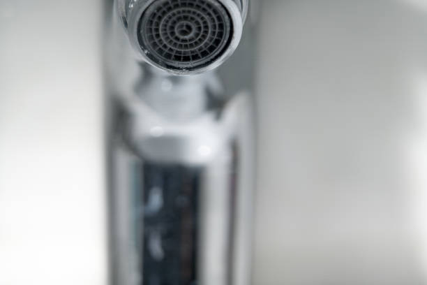 istock water drop on faucet, world water day concept with copy space 935951390