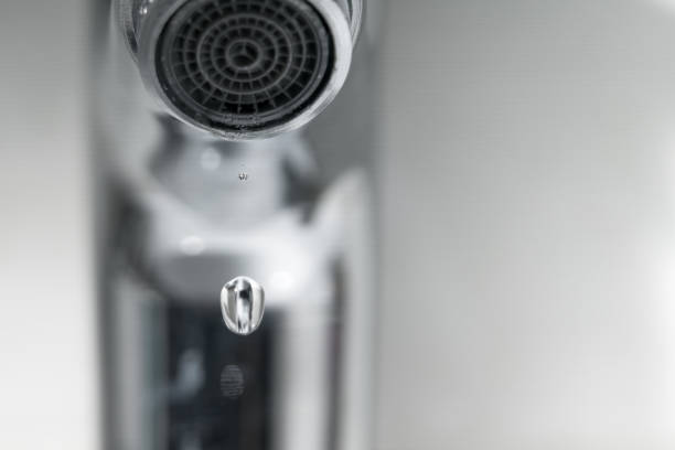 istock water drop on faucet, world water day concept with copy space 935951588