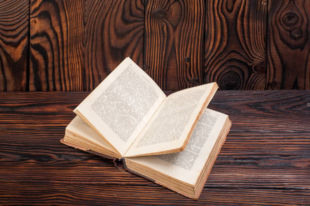 istock Old books on a wooden background 935951636