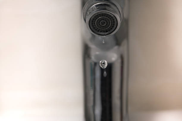 istock water drop on faucet, world water day concept with copy space 935951648