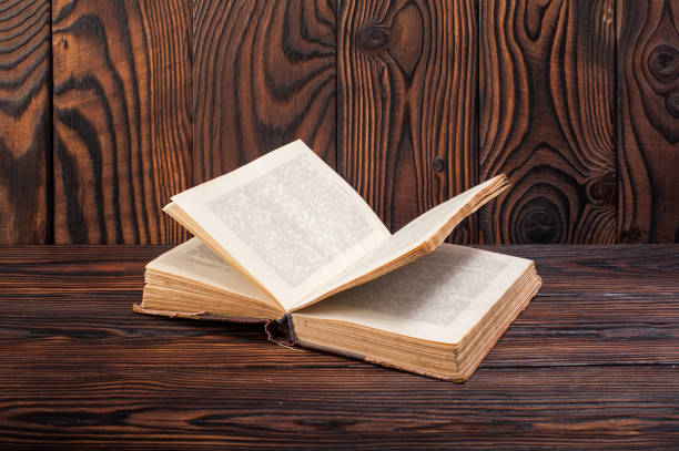 istock Old books on a wooden background 935951692