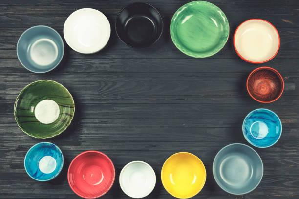 istock food, cooking, Multicolored bowls, utensils, concept, black tabl 935954584