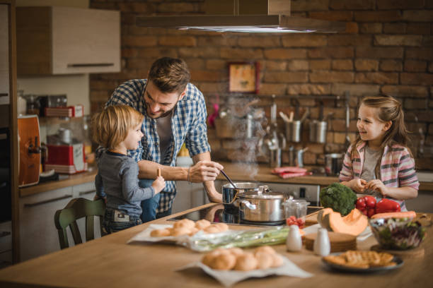 istock Father's cutest assistance in the kitchen! 935957862