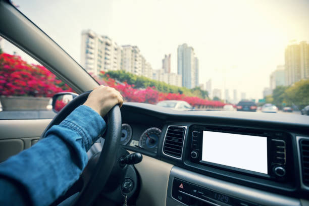 istock Hands on wheel driving car in city 935963056