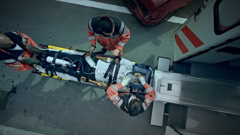 CS Paramedics loading the injured woman on the stretcher into the ambulance