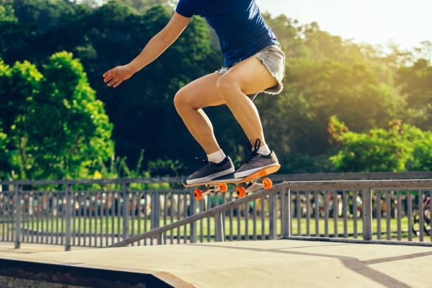 istock female skateboarder legs skateboarding at skatepark 935964086