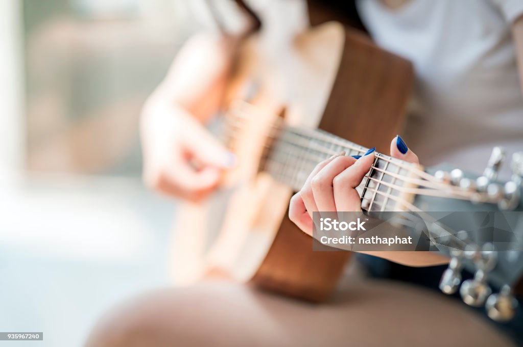 mujer de las manos tocando la guitarra acústica - Foto de stock de Guitarra libre de derechos