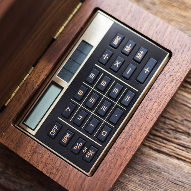 istock Calculator closeup on wooden background 935967542