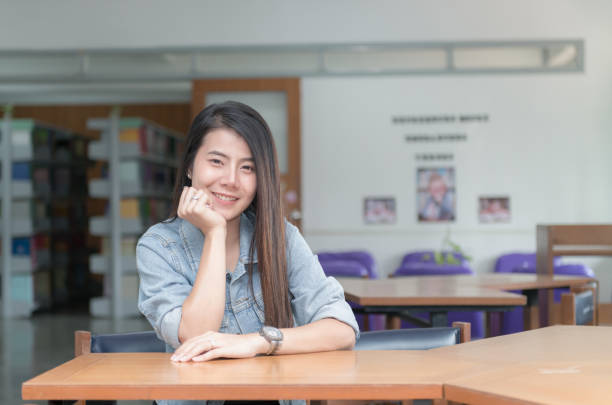 istock Confident smiling student asian girl in the library university 935967624