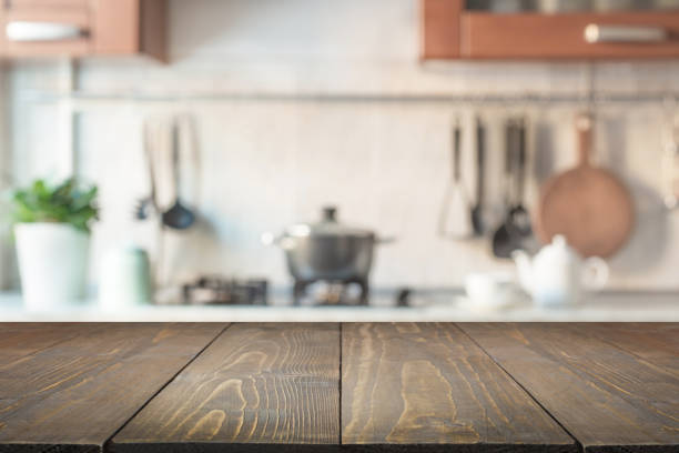 Blurred abstract background. Modern kitchen with tabletop and space for display your products. Blurred abstract background. Modern kitchen with wooden tabletop and space for display or montage your products. cooking show stock pictures, royalty-free photos & images