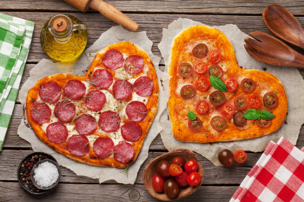 istock Heart shaped pizza with tomatoes and mozzarella and pepperoni 935974066