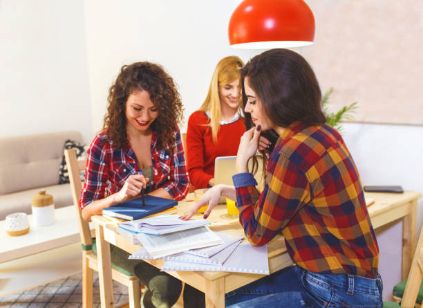 istock Group of female students study at home, learning for university exam. 935974290