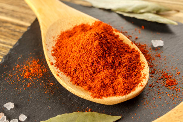 istock Red pepper ground. Spicy seasoning, on the kitchen table, Close-up. 935979536