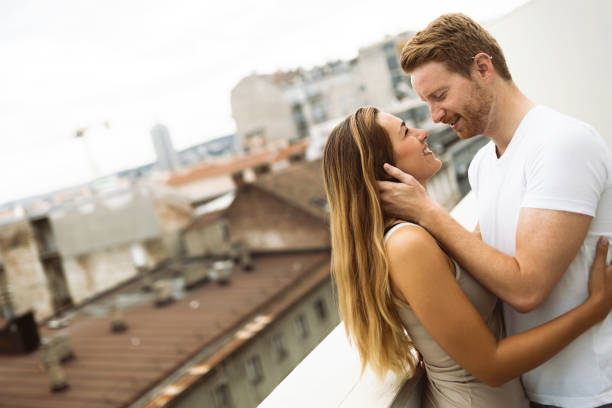 istock Romantic couple kissing on rooftop 935979540