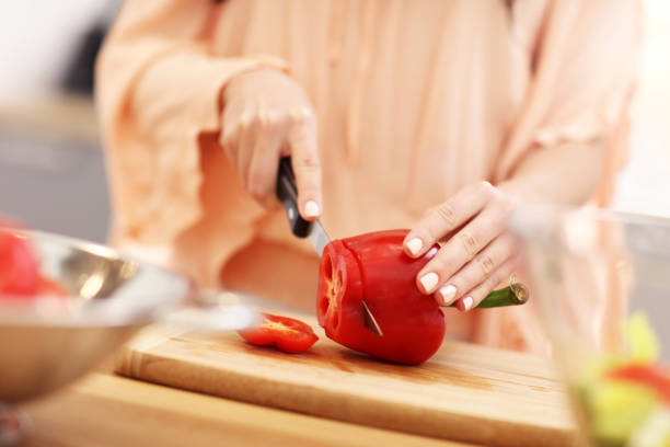 istock Happy woman preparing salad in modern kitchen 935979588
