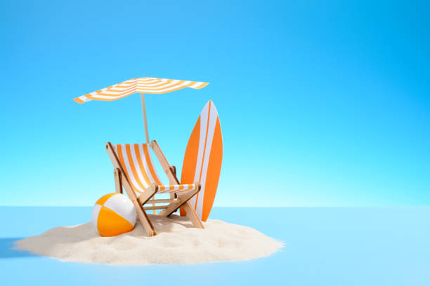 Paradise island in the ocean. Paradise island in the ocean. Miniature beach accessories for outdoor activities. Blue background with copy space chaise longue stock pictures, royalty-free photos & images