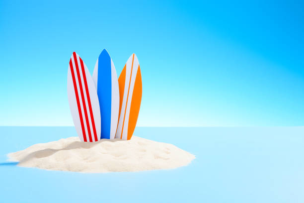 istock Active recreation background. Three surfboards on a sandy island 935979748