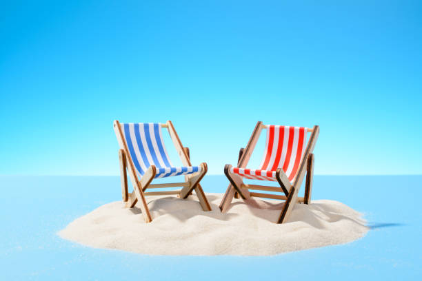 istock Two sun loungers on a sandy island, copy space 935979764