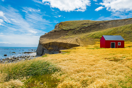Red fisherman's cottage near the coast in the small village Cameron. Tierra del Fuego, Chile