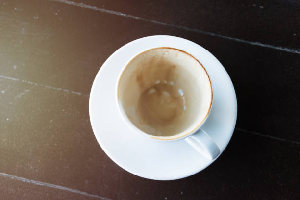 istock cup of coffee is waiting to be cleaned.Empty coffee cup after drink.coffee stained after drink 935983070
