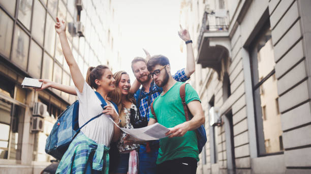 Happy group of tourists traveling and sightseeing Happy group of tourists traveling and sightseeing together student travel stock pictures, royalty-free photos & images