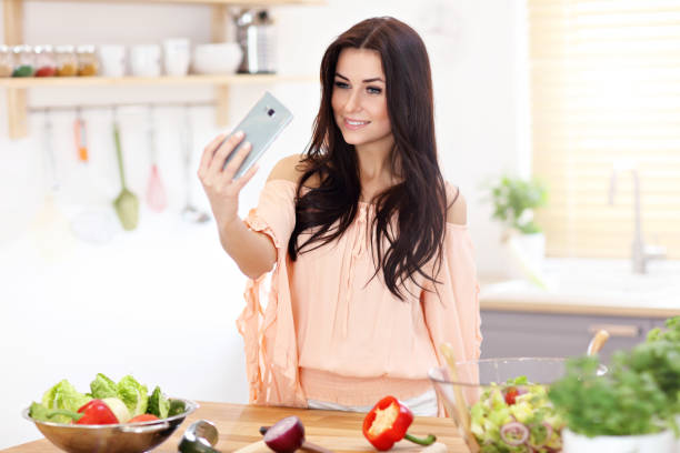istock Happy woman preparing salad in modern kitchen 935983122
