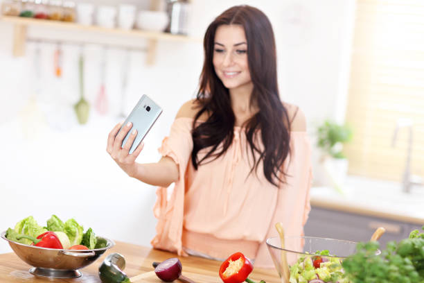 istock Happy woman preparing salad in modern kitchen 935983174