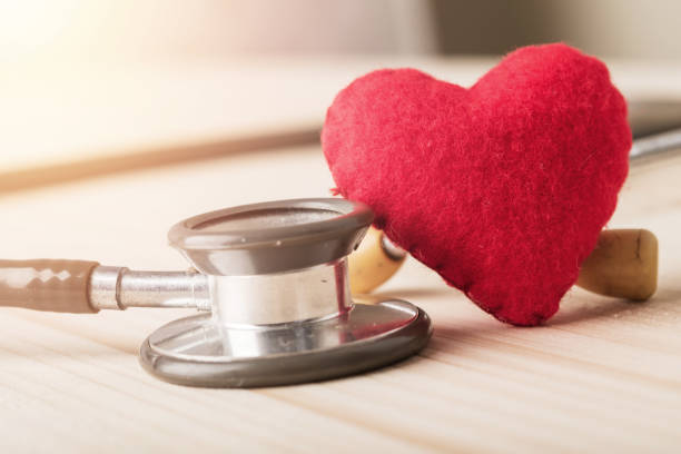 istock Single red heart on wooden background 935983508