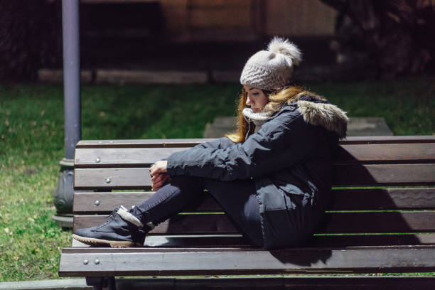 istock Depressed woman sitting alone at night 935986982