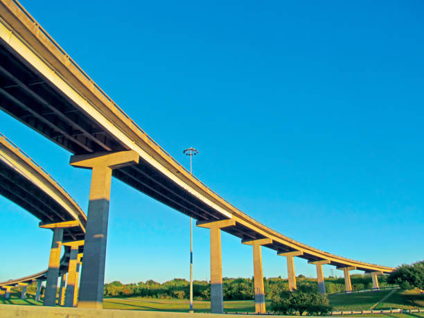 istock Bridges of elevated roads against a bright clean blue sky background. 935989704