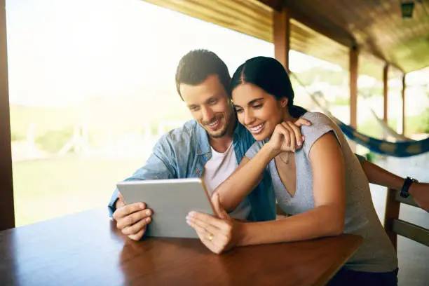 Cropped shot of an attractive young married couple using a tablet together at home