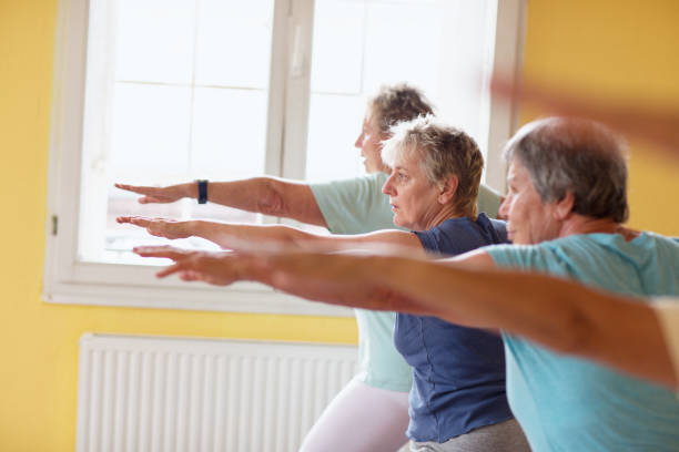 istock active senior women in yoga class warrior pose 935990778