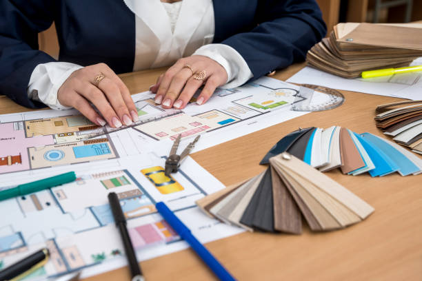 istock nterior designerwith color swatch and building plans on office 935993126