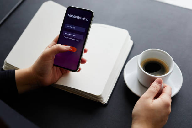istock Female hands using mobile banking on smartphone 935994296