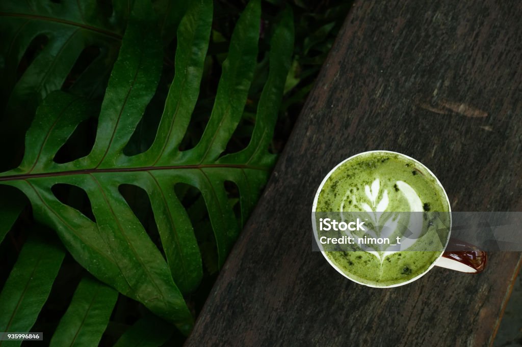 A cup of green tea matcha latte A cup of green tea matcha latte on wooden background Matcha Tea Stock Photo